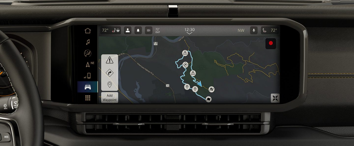 A close-up of the Uconnect touchscreen in the 2025 Jeep Wrangler displaying one of the Off-Road Trail Guides.