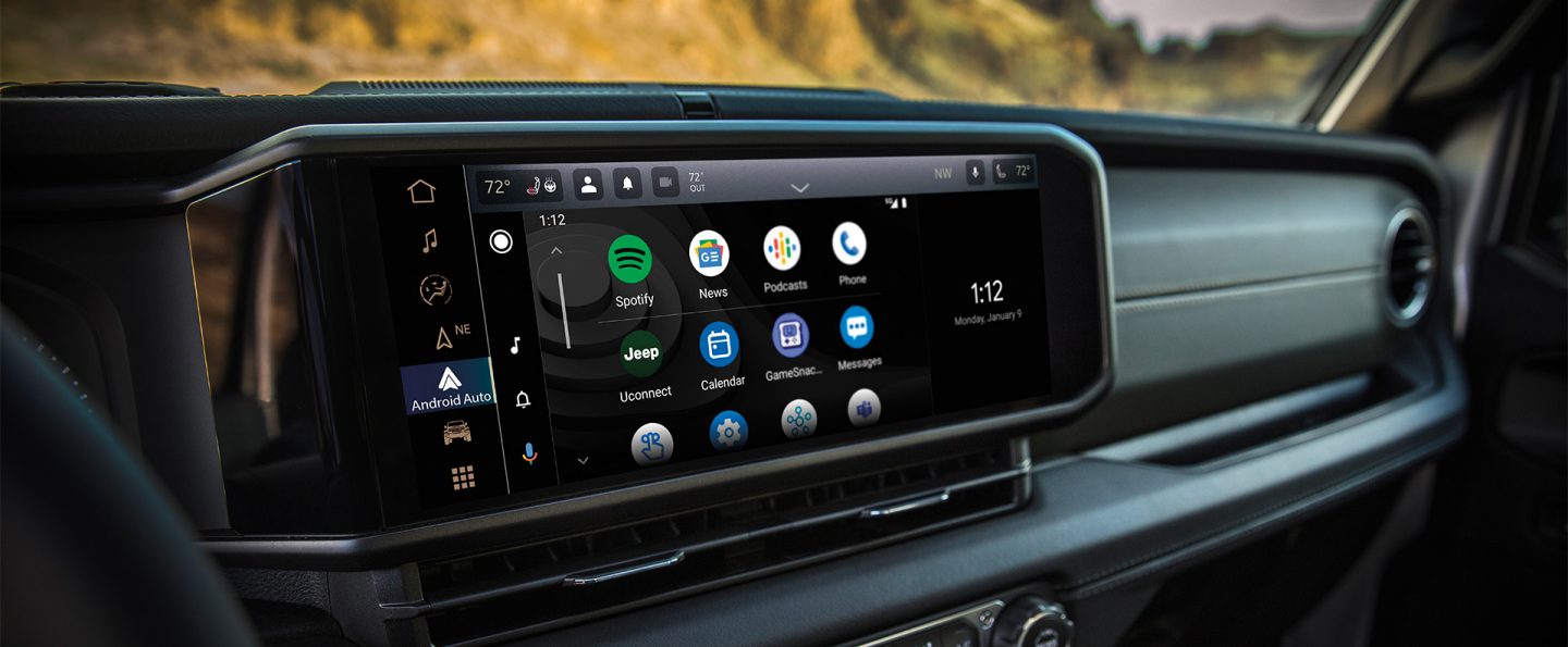 A close-up of the Uconnect touchscreen in the 2025 Jeep Wrangler displaying a series of Android Auto selections and the current date and time.