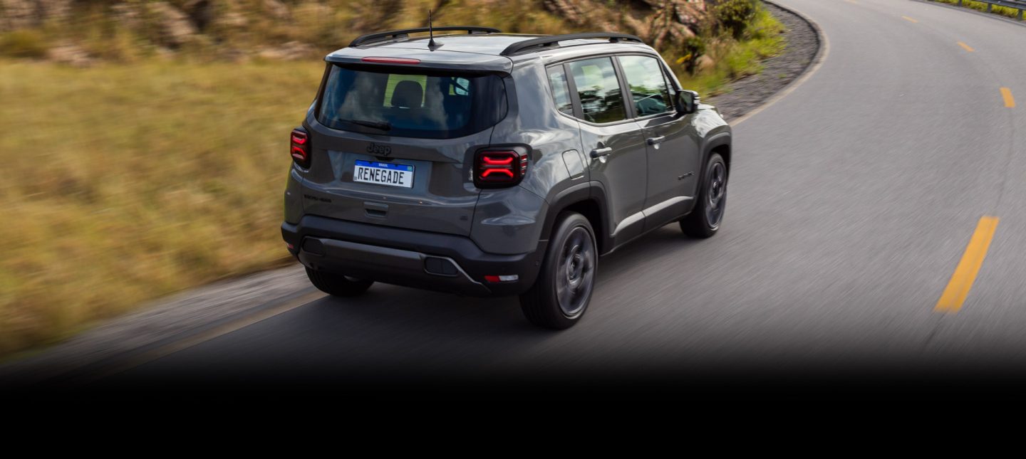 The 2023 Jeep Renegade Trailhawk being driven over a bridge with a kayak and a mountain bike secured to its roof rack.